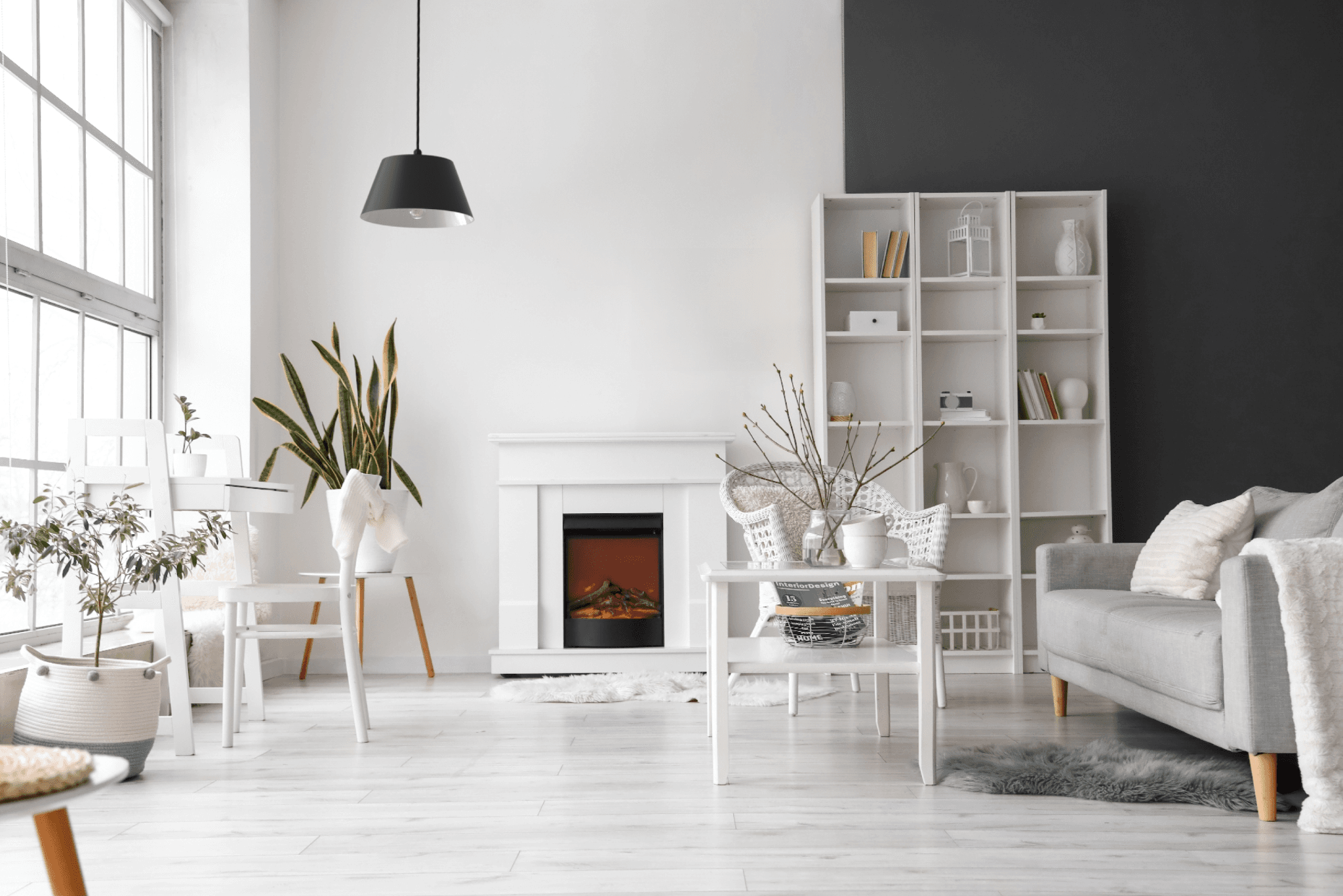 Modern living room with cozy decor, pendant light, and natural elements. Bright and inviting atmosphere.