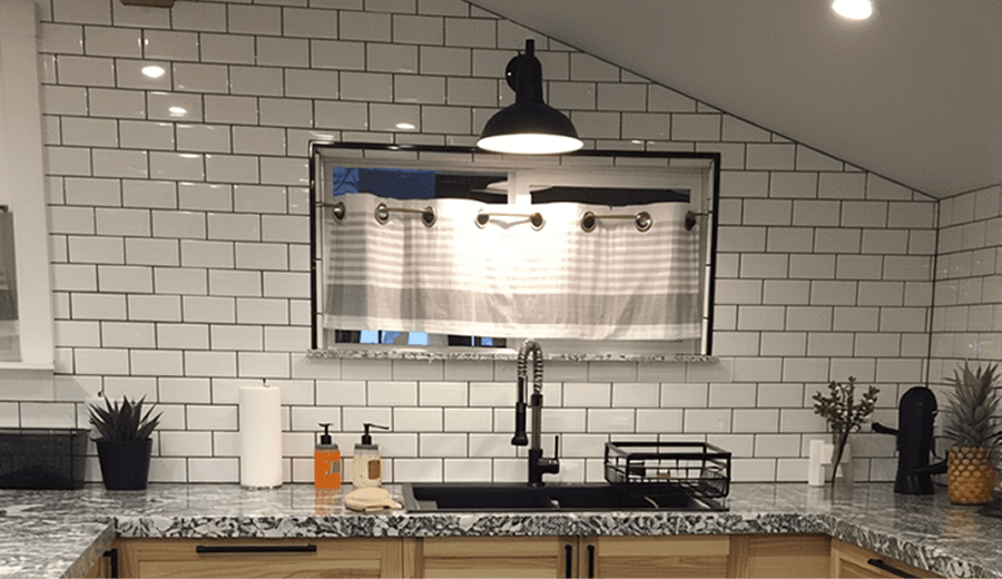 Wall sconces near a kitchen sink area
