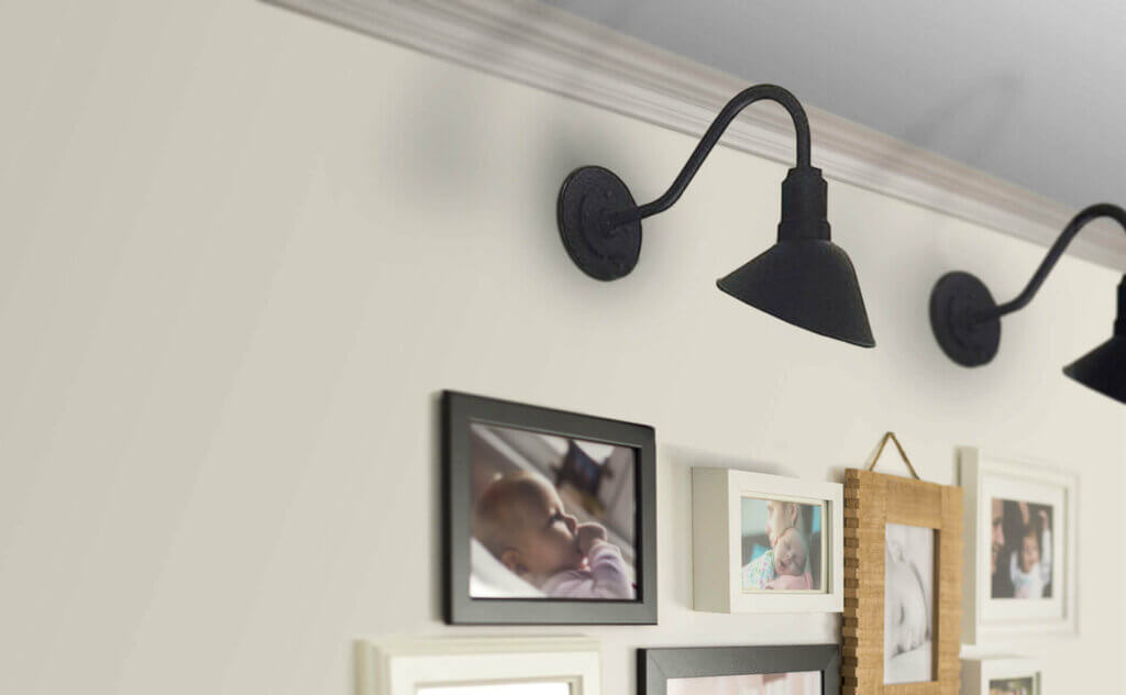 Wall mounted light fixtures above pictures in black