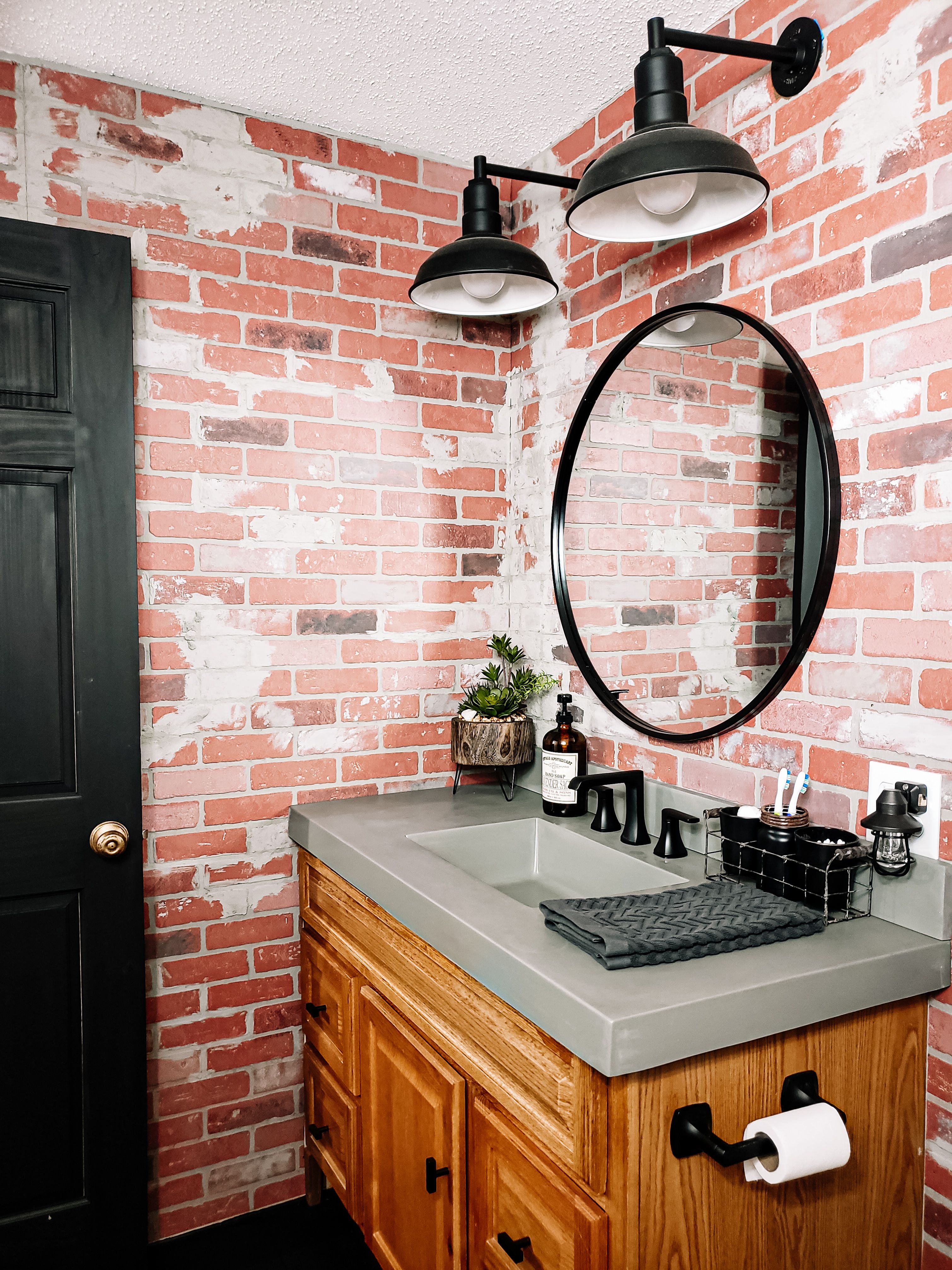 https://steellightingco.com/wp-content/uploads/2021/05/black-westchester-straight-arm-brick-bathroom.jpeg