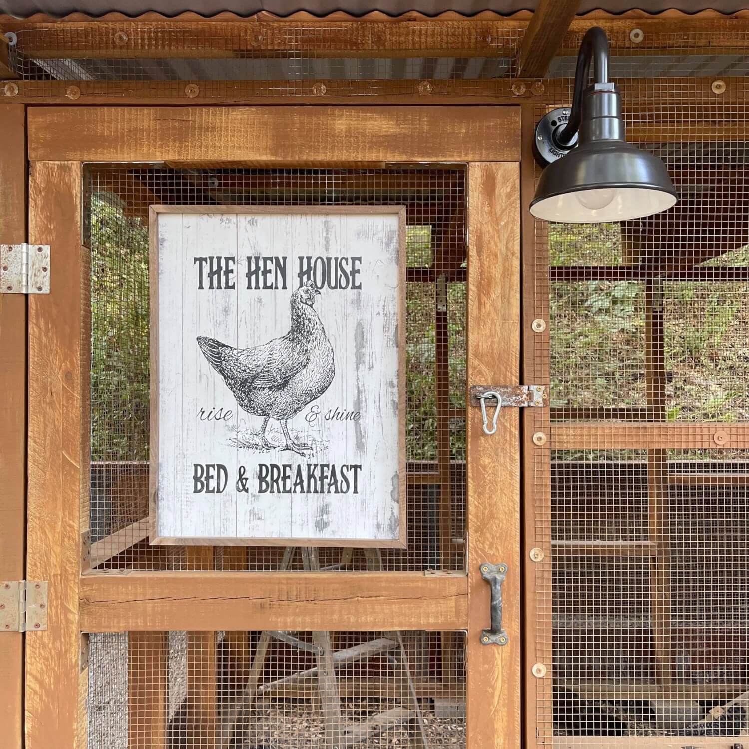 The Hen House Chicken Coop Sign next to Steel Barn Sconce