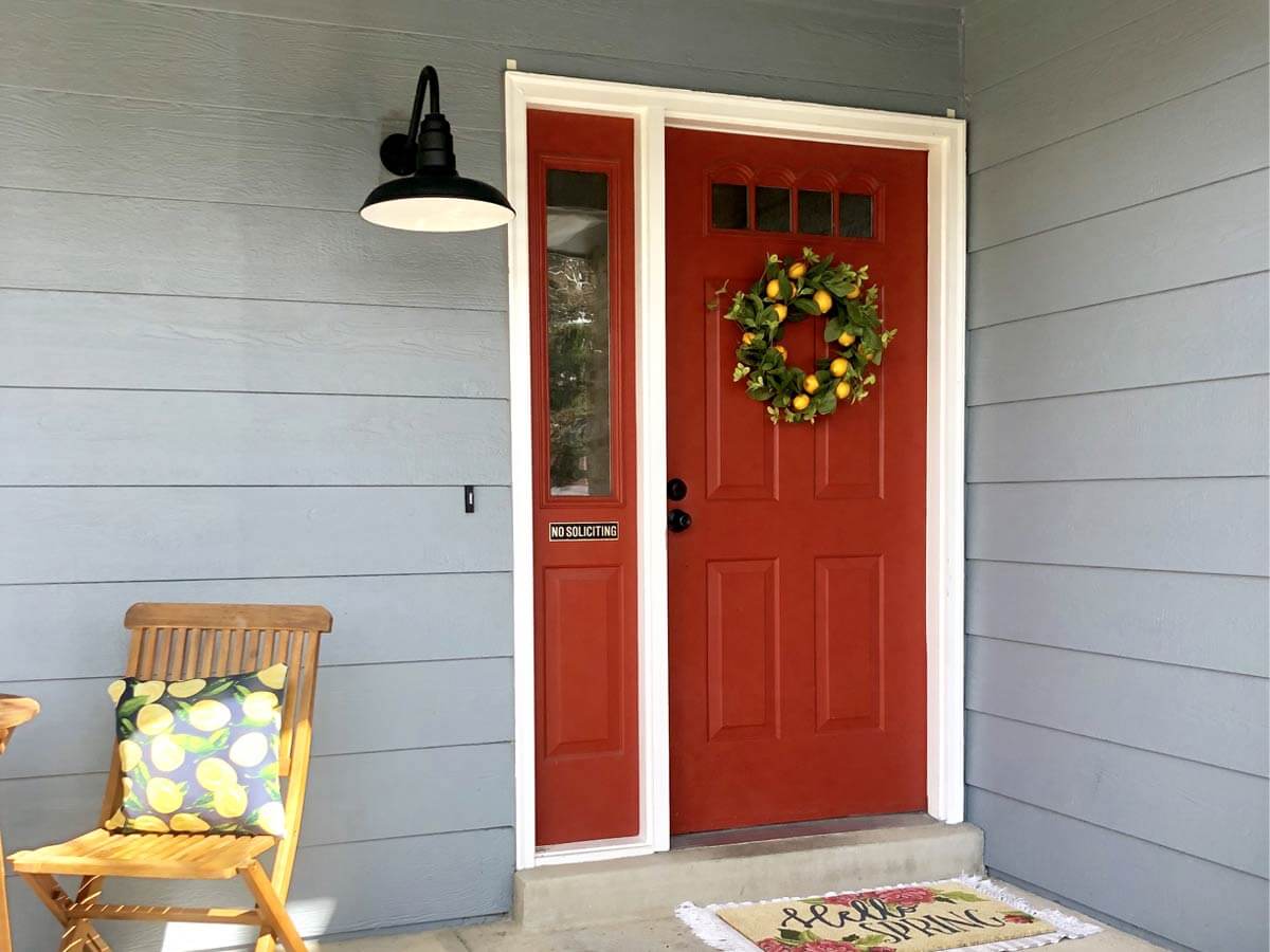 Small matte black barn light installed on porch