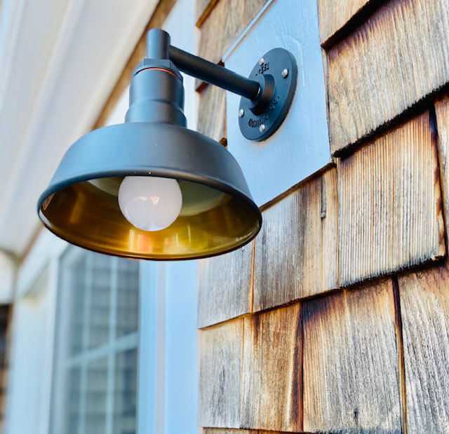 Matte black with brass sconce on porch
