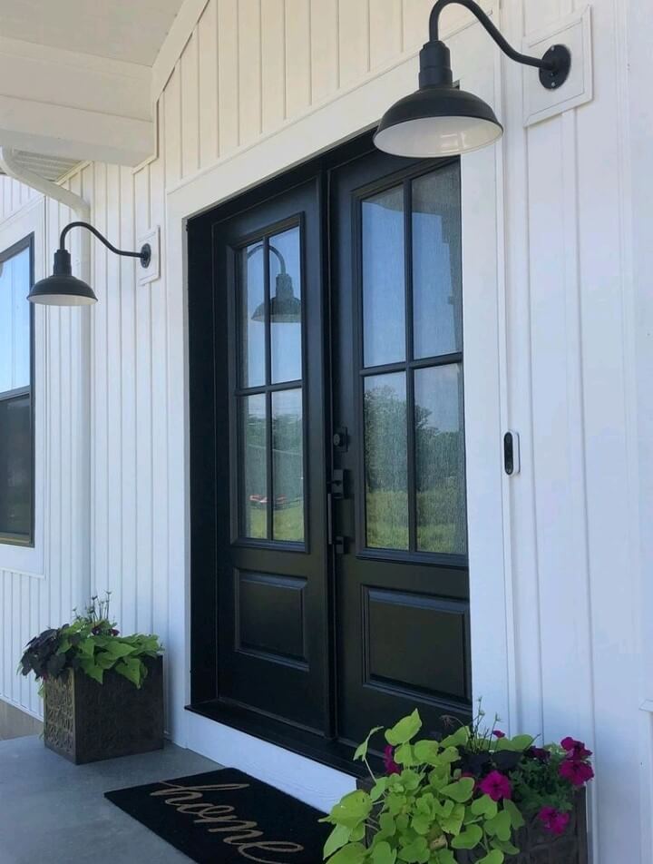 Succulents on a beautifully designed porch paired with steel sconces