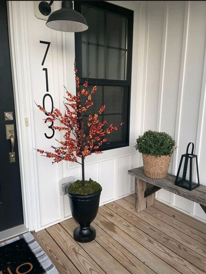 A steel sconce highlighting a porch plaque